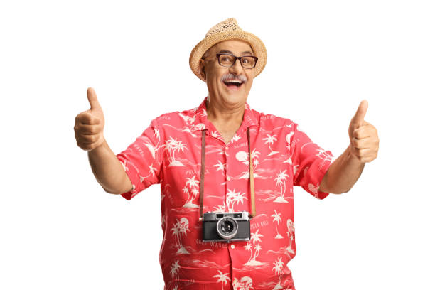 Happy male tourist with a camera gesturing thumbs up stock photo