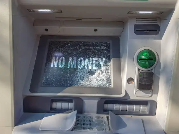 Photo of Broken ATM. Cash machine with broken glass