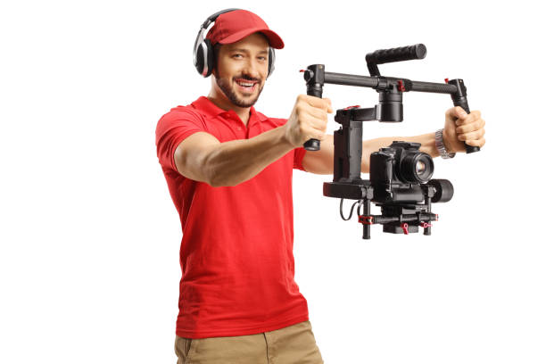 istock Man with headphones operating a camera gimbal stabilizer 1417941325