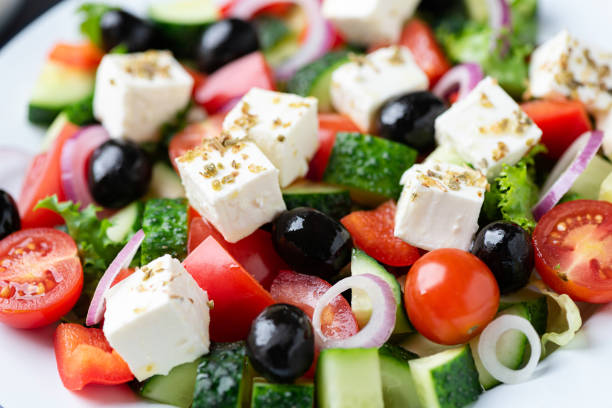 Greek salad with feta and black olives Greek salad with feta and black olives as background, closeup view greek food stock pictures, royalty-free photos & images