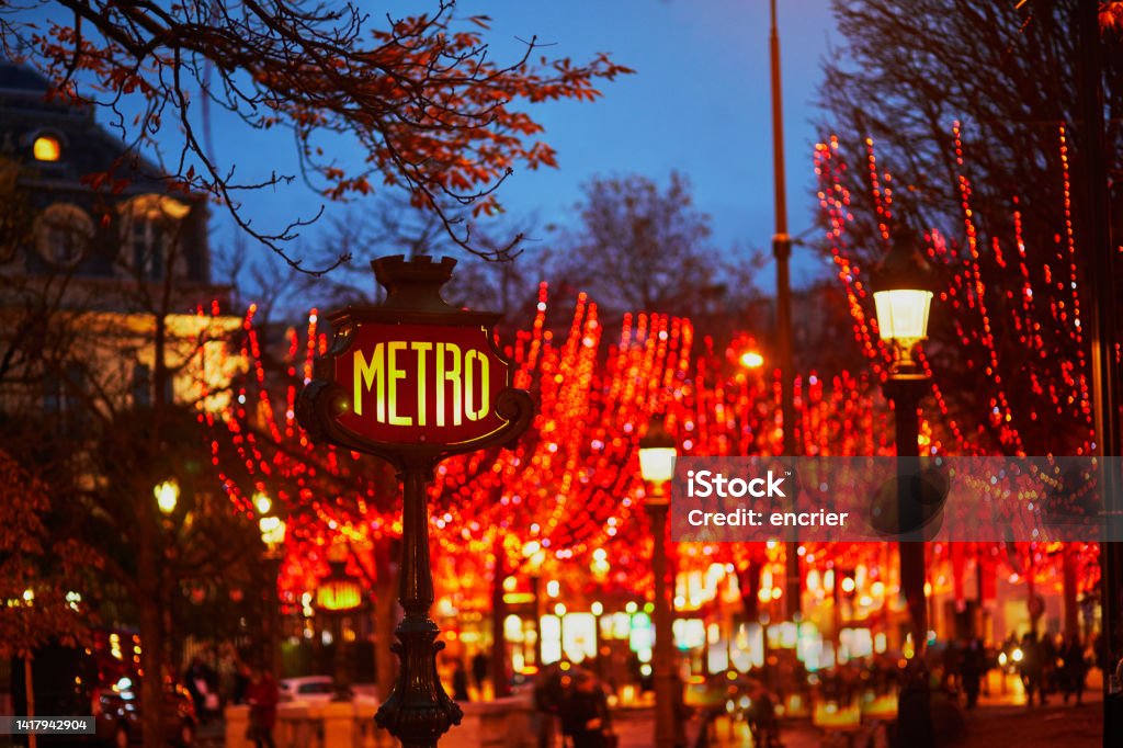 Subway station sign and seasonal holiday illumination on Champs Elysees street in Paris, France Subway station sign and seasonal holiday illumination on Champs Elysees street in Paris, France. Celebrating Christmas and New Year in French capital Paris - France Stock Photo
