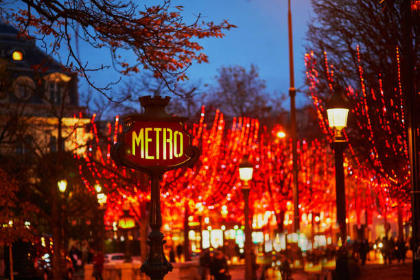 Subway station sign and seasonal holiday illumination on Champs Elysees street in Paris, France stock photo