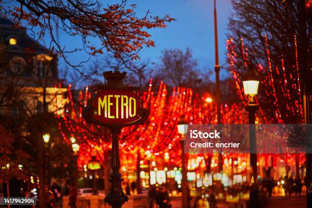 Subway Station Sign And Seasonal Holiday Illumination On Champs Elysees Street In Paris France Stock Photo - Download Image Now
