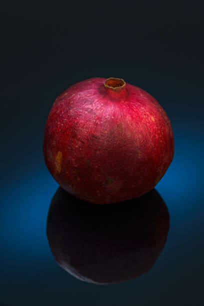 Still life with red pomegranat on the black background stock photo