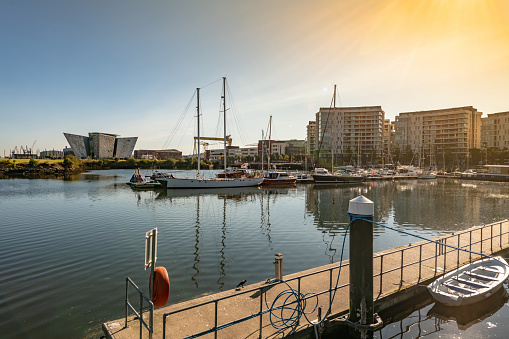 Modern buildings, boats and the wider harbour in Belfast's Titanic Quarter area