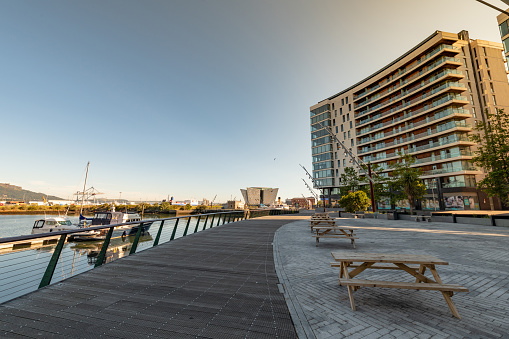 Modern buildings, boats and the wider harbour in Belfast's Titanic Quarter area