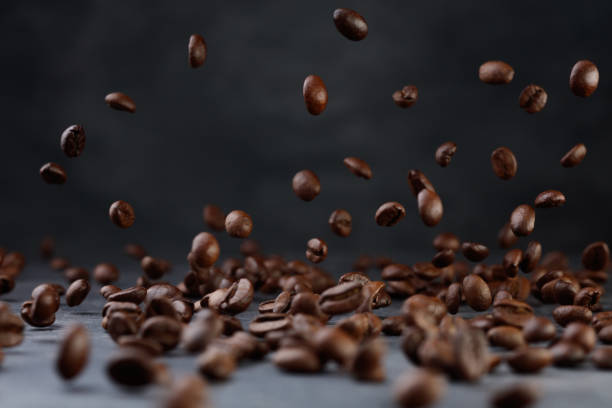 istock Many roasted coffee beans flying in the air. 1417946518