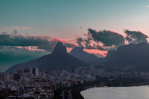 The coastline tropical city buildings and mountains under the sunset sky in Rio de Janeiro