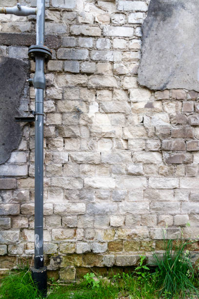 istock Old cracked plaster and brick wall 1417949529