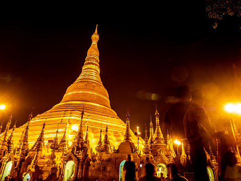 The Ghost Image and Lens Flare in the picture of group of golden pagodas and mondops are illuminated in the light of the night