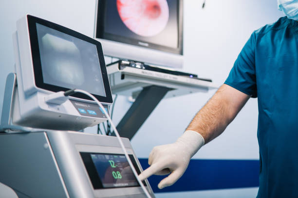 Doctor preparing medical equipment for the operation Image of a doctor preparing instruments and the medical room for the surgery. colonoscopy stock pictures, royalty-free photos & images