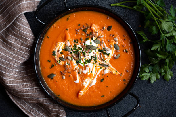 istock Pumpkin soup with cream and parsley in bowl 1417952548