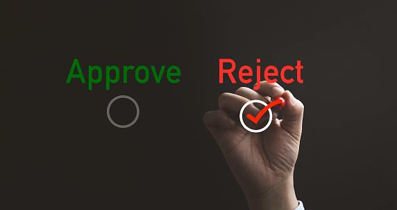 Hand writing red tick mark to choose reject item , Approve and reject business and document concept.