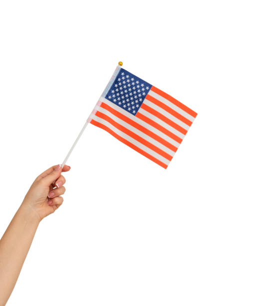 istock Female hand holding american flag isolated on white background 1417954264