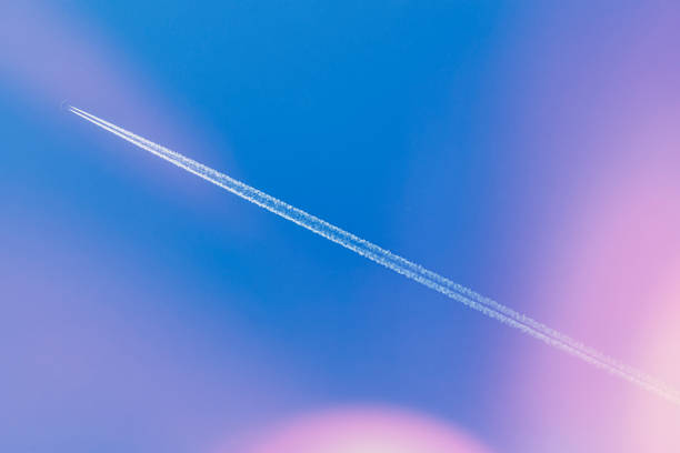 Airplanes leaving contrail trace on a clear blue sky Airplanes leaving contrail trace on a clear blue sky supersonic airplane stock pictures, royalty-free photos & images