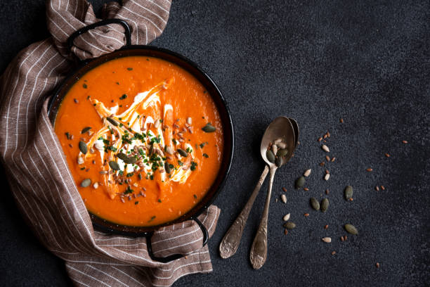 istock Pumpkin soup with cream and parsley in bowl 1417954596