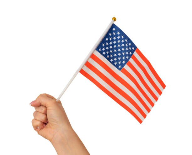 istock Female hand holding american flag isolated on white background 1417954844