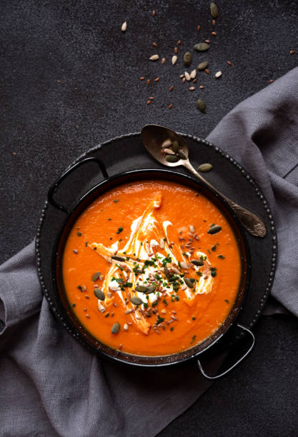 istock Pumpkin soup with cream and parsley in bowl 1417957061