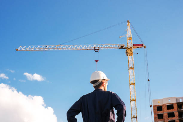 istock engineer in uniform and safety helmet at construction site checks work 1417962933