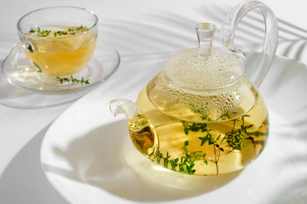 istock herbal tea with thyme in glass teapot. White background with copyspace. 1417965161