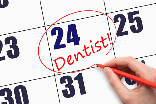 24th day of the month. Hand writing text DENTIST and circling the calendar date. Dentist Healthcare Medical Schedule Appointment Concept. Day of the year concept.