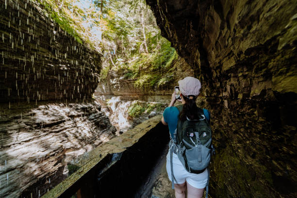 woman doing hike around river with waterfall