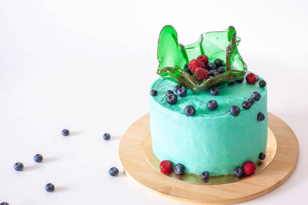 istock Green cake with blueberry on white background 1417970280