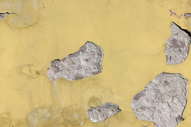 istock Damaged yellow plaster of a concrete wall 1417970844