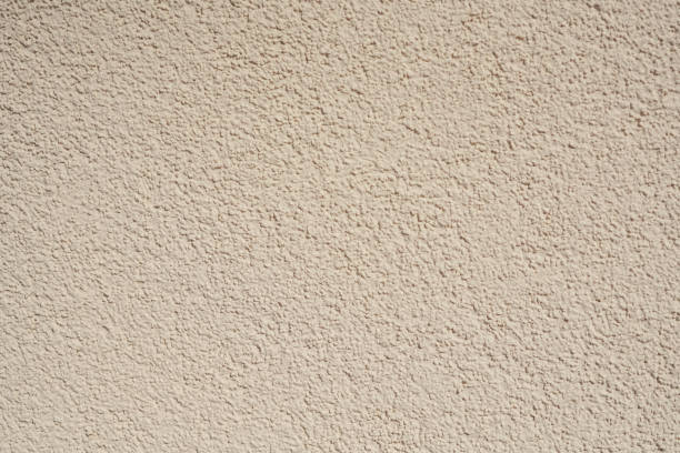 Structural plaster wall in beige color. Creative vintage background