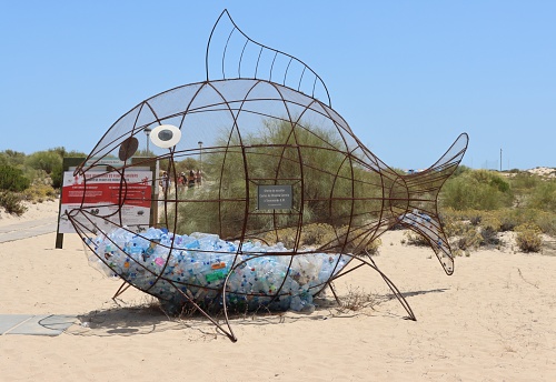 Ilha de Tavira - Portugal - July 11, 2022. \nA fish shaped bin for plastic collection on Tavira Island beach.
