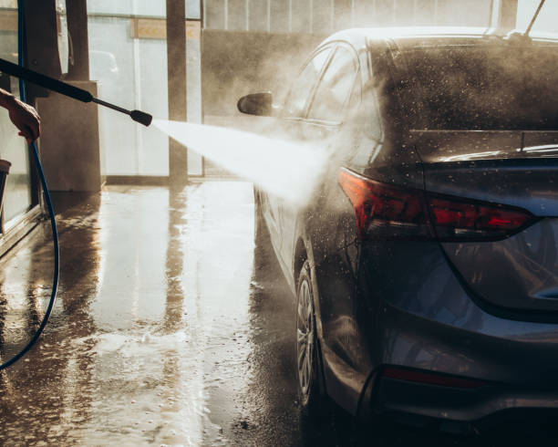 istock A man washes his car at a self-service car wash using a hose with pressurized water 1417974608