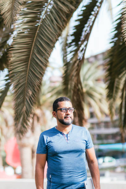 istock young entrepreneur walking down street with his laptop 1417974918