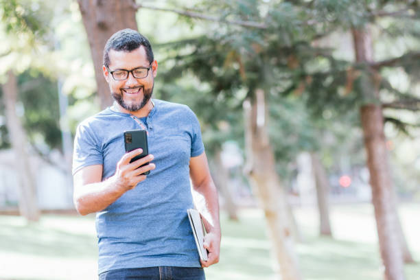 istock handsome businessman using his smartphone in park 1417974947
