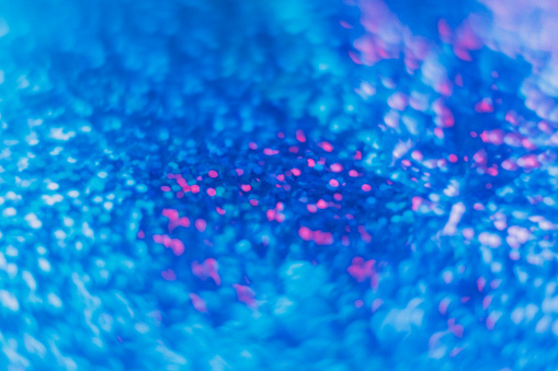 Blur light flare. Bokeh glow overlay. LED radiance reflection. Defocused neon blue pink color shiny round glitter glare decorative abstract background.