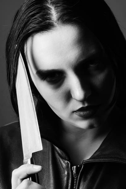 istock woman with knife 1417978154