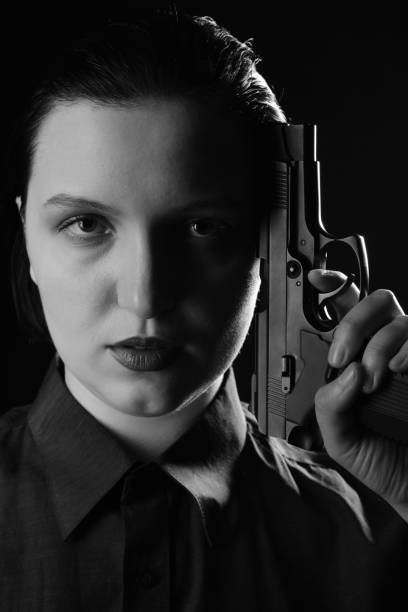 istock woman with gun 1417978287