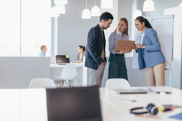 istock Woman discussing data with colleagues in a meeting. 1417979559