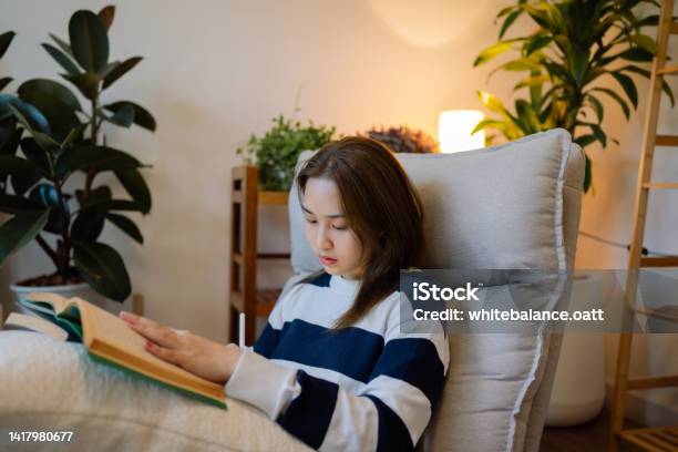 Asian Woman Writes A Text Based On A Book On Her Tablet Stock Photo - Download Image Now