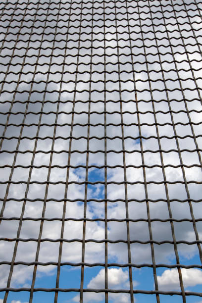 istock Metal grating on a blue sky background 1417982790