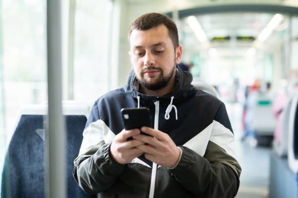istock Young man using smartphone during trip in public transport 1417984357
