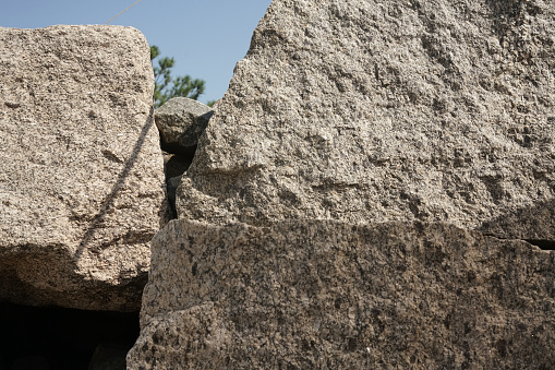 Structure of granite. Large stones on the seashore. Creative vintage background