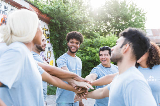 istock Multiracial group of volunteers put hands together in unity 1417984750