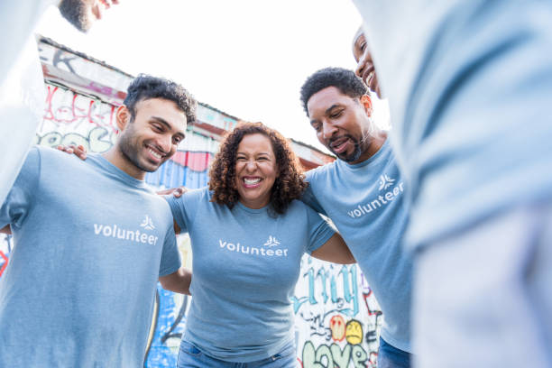 istock Low angle view cheerful, diverse volunteers in huddle 1417984789