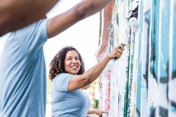 istock Mother smiles at unrecognizable son while volunteering for park clean-up 1417985373