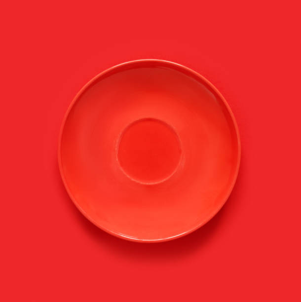 istock Red plates on red table. Monochrome minimalistic image in hipster style. 1417986658