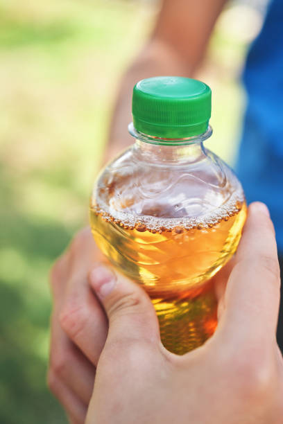 istock Young Teens Holding Plastic Bottle of Apple Soda 1417990344