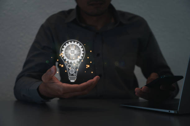 istock Hand of a man with a light bulb And there is a gear icon in it and he is using a notebook computer. The idea of inspiration from online technology.innovation idea concept. 1417990347