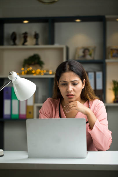 istock Thoughtful businesswoman using laptop at home 1417990485