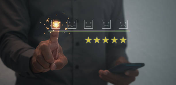 User give satisfaction in service. rating very impressed. Customer service and Satisfaction concept ,Business people are touching the virtual screen on the happy Smiley face and giving star icon.