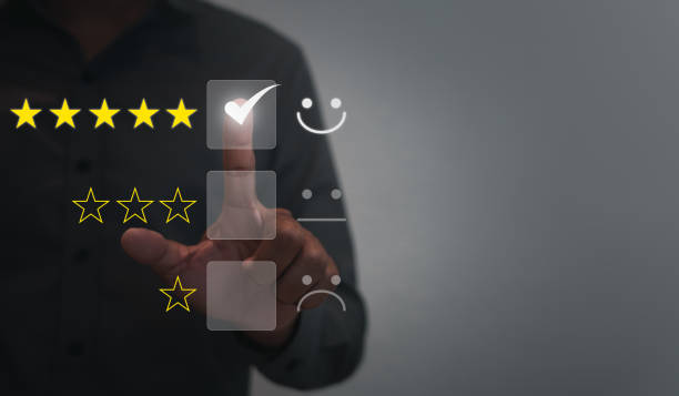 User give satisfaction in service. rating very impressed. Customer service and Satisfaction concept ,Business people are touching the virtual screen on the happy Smiley face and giving star icon.